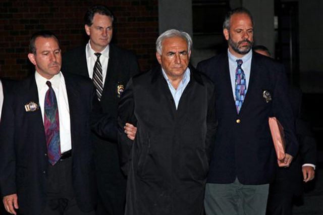 Dominique Strauss-Kahn being escorted by cops on Sunday